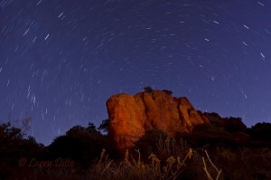 Star trails around a light-painted bluff, one hour before sunrise.