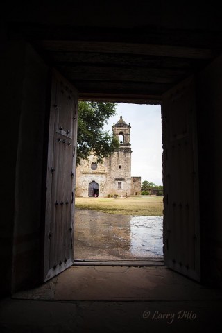 Looking through a doorway at historic Mission San Jose, San Antonio.