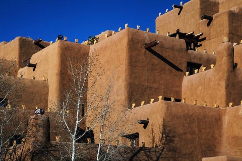 A Santa Fe hotel with luminaria along the walls.