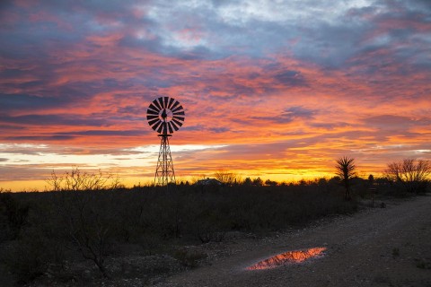 Windmill and cloud reflection at sunset.