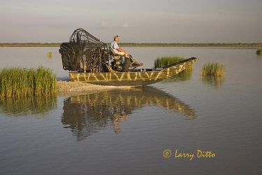 Ken Nolte of Port Mansfield, Texas heading his air boat across the shallow flats of the Laguna Madre. Ken is able to access the shallows where normal boats can't go for fishing, sight seeing and waterfowl hunting.