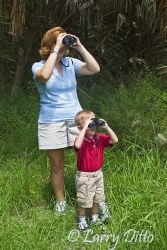 Mother teaching son about birding, s. Texas.