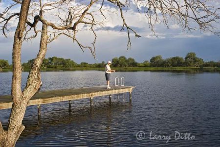 Bass fishing from a pier on a s. Texas lake