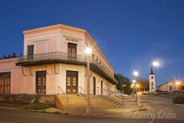 Full moon rising on the historic Roma Plaza in early evening. The historic Guerra Store (left) sits across the plaza from the Roma World Birding Center. It was partially restored in recent years to preserve the city's unique architecture. At the far end of the plaza rises the original steeple of Our Lady of Refuge Parish Church constructed in the 1850s.