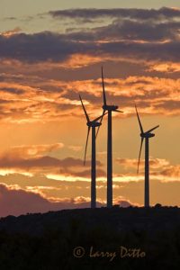 Wind driven turbines near Snyder, Texas. "Wind Farm" generates electricity using wind power; sunset