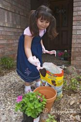 Little girl gardening for grandma.