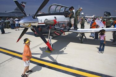 Kids love the Commerative Air Force Air Fiesta in Brownsville, Texas because they can climb right up by the cockpit and talk to real pilots.