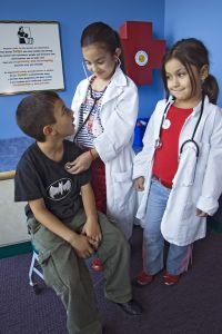 Rene, Jazmine and Pamela (left to right) Arce playing doctor & patient at the Children's Museum in Brownsville, Texas
