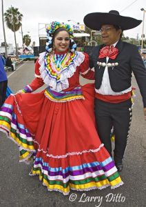 Dancers in "Grupo Folklorico de Tizatlan" represent the University of Texas - Brownsville and Texas Southmost College at the Charro Days Festival street dance in Brownsville, Texas